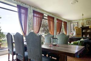 a dining room with a wooden table and some windows at Il Broglino in Todi