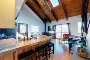 a kitchen with a large bar with stools at Overlook Nook in Stateline