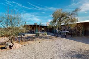 a building with a fence in front of it at Lazy C Ranch in Tucson