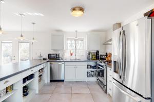a kitchen with white cabinets and a refrigerator at Lazy C Ranch in Tucson
