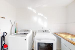 a kitchen with a stove and a washer and dryer at Lazy C Ranch in Tucson