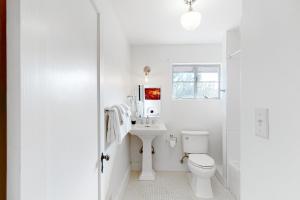 a white bathroom with a sink and a toilet at Lazy C Ranch in Tucson +22 photos