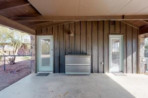 an empty house with two doors and a stove at Lazy C Ranch in Tucson