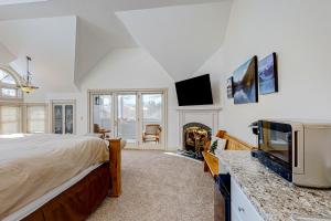 a bedroom with a bed and a tv and a fireplace at The Rest in Jackson