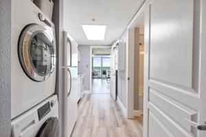 a hallway with a washer and dryer in a house at Bay Watch 0439 in Myrtle Beach