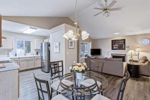 a kitchen and living room with a glass table and chairs at Pine Ave Delight in Coeur d'Alene