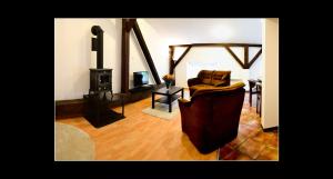 a living room with a chair and a wood stove at 777 Apartments 2 in Krakow