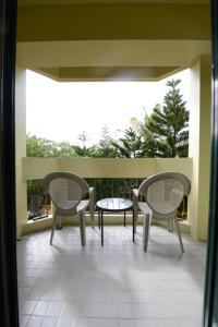 two chairs and a table on a balcony at Days Inn Guam - Tamuning in Tamuning