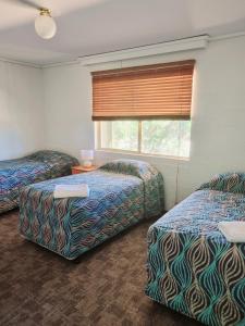 a hotel room with two beds and a window at Bremer Bay Resort in Bremer Bay