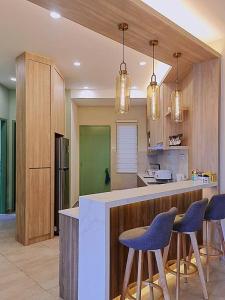 a kitchen with blue bar stools and a counter top at NEW Condo Atlantis Melaka Town @ Memories in Melaka