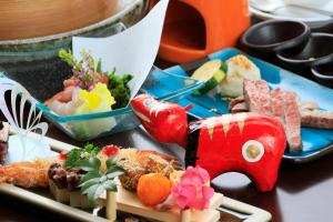 a plate of food on a table with sushi at Yutoriro Bandai Atami in Koriyama