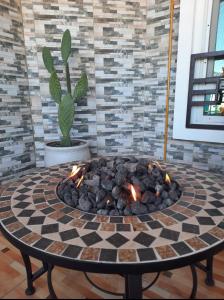 un focolare nel mezzo di una stanza di Fig House Villa with Heated Swimming Pool & Firepit ad Al ‘Aqar