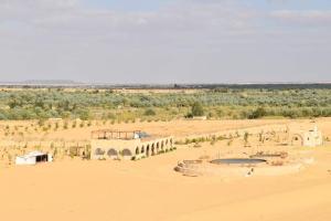 a building in the middle of a desert at Hayaat siwa hot spring in Siwa +88 photos