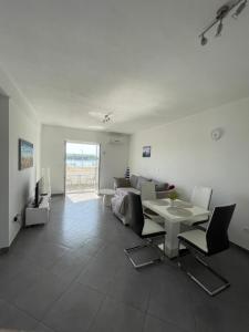 a living room with a table and a couch at Apartments Nevistic in Podstrana