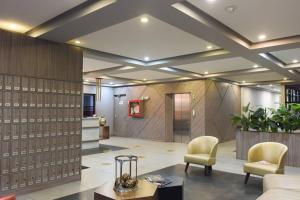 a lobby with two chairs and a table at Downtown Bogota Centro Internacional in Bogotá