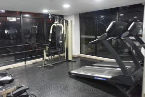 a gym with a treadmill and a large window at Downtown Bogota Centro Internacional in Bogotá