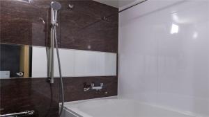 a bathroom with a shower and a mirror at KYOTO GION HOTEL in Kyoto