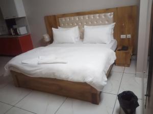 HisārにあるHotel veersarthak residencyのベッドルーム1室(大型ベッド1台、白いシーツ、枕付)