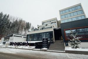 a building with a sign in front of it at Fabesca Boutique Hotel & SPA in Sovata