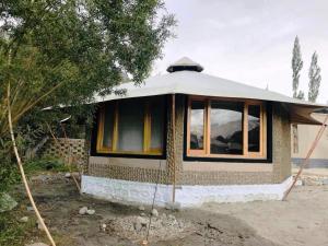 a small house with a large window at Chalet Seabuckthorn - Hunder in Hundar
