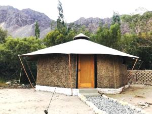 a small hut with a large white umbrella at Chalet Seabuckthorn - Hunder in Hundar