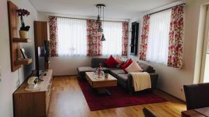 a living room with a couch and a coffee table at Steppacher Ferienappartements in Friedenweiler