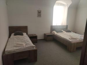 Postel nebo postele na pokoji v ubytování Penzion Klášterský mlýn