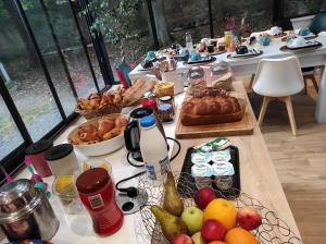 a long table with a bunch of food on it at Le Clos de la Commanderie in Amboise +44 photos