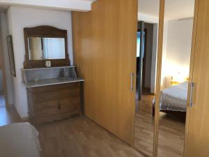 a bathroom with a sink and a mirror and a bed at Albergo Diffuso Porrentruy in Porrentruy +37 photos