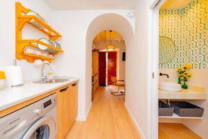 a kitchen with a sink and a washing machine at CASA EL RINCONCITO in Antequera +77 photos