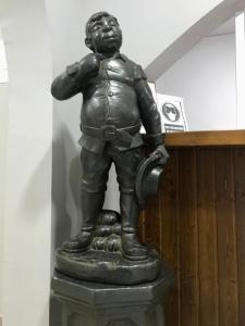 a statue of a man holding a water hydrant at Hotel Cervantes in Zafra