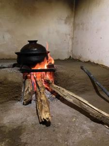 a pot is sitting on top of a fire at Organic farm Wish Prabha lake view homestay in Sigiriya