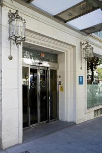an entrance to a building with revolving doors at II Castillas Madrid in Madrid