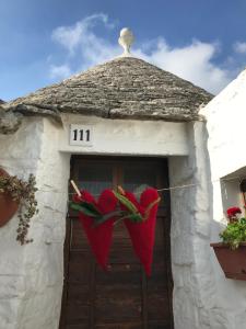 une porte avec un parapluie au-dessus dans l'établissement Trulli Aria di Casa, à Alberobello