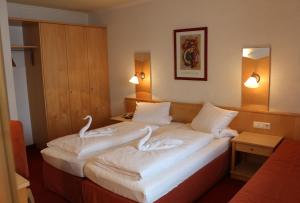 Postel nebo postele na pokoji v ubytování Alpenhotel Regina