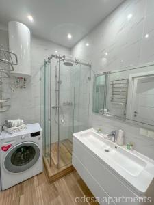 a bathroom with a washing machine and a sink at Sea View Sky 15 Апартаменти в Одесі in Odesa