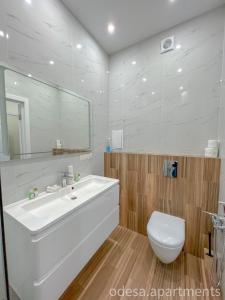 a bathroom with a white sink and a toilet at Sea View Sky 15 Апартаменти в Одесі in Odesa