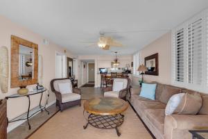 a living room with a couch and a table at Gulf Winds 101 in Pensacola Beach