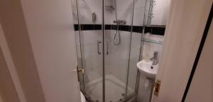 a bathroom with a glass shower and a sink at Colebrook Guest House in Farnborough +33 photos