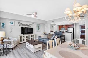 a living room with a kitchen and a dining room at Grand Sandestin 2800 in Destin