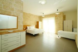 a bedroom with two beds and a sink and a mirror at Camere a Sud in Alliste