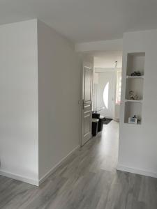 an empty room with white walls and wood floors at Au cœur des Vosges in Saint-Étienne-lès-Remiremont +1 photo