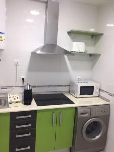 A kitchen or kitchenette at Apartamentos Catedral Escalinata