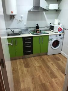 A kitchen or kitchenette at Apartamentos Catedral Escalinata