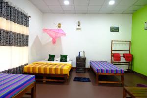 Ένα ή περισσότερα κρεβάτια σε δωμάτιο στο Thilina Homestay +15 φωτογραφίες