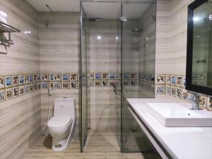a bathroom with a toilet and a sink and a shower at Victory Hotel, số 7, Vương Thúc Mậu, Tp Vinh in Vinh +17 photos