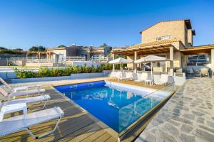 a villa with a swimming pool and a house at Sol Pedra Villas in Skala Marion