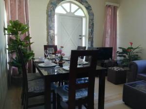 a dining table and chairs in a living room at Vacances Le Nereide Blue Bay in Blue Bay
