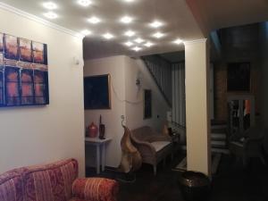 a living room with a couch and a stair case at B&b kabbala club in Lattarico