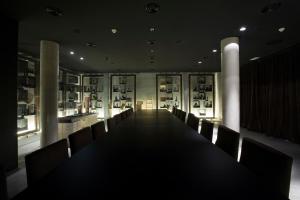 a long table with chairs in a room with photos at Finca Prats Hotel Golf & Spa in Lleida